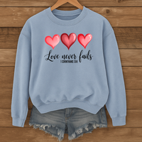 Load image into Gallery viewer, Love Never Fails Christian Sweatshirt, Faith Based Valentine Gift Crewneck, 3 Heart Design, Corinthians 13:8