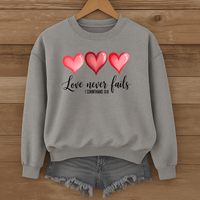 Load image into Gallery viewer, Love Never Fails Christian Sweatshirt, Faith Based Valentine Gift Crewneck, 3 Heart Design, Corinthians 13:8